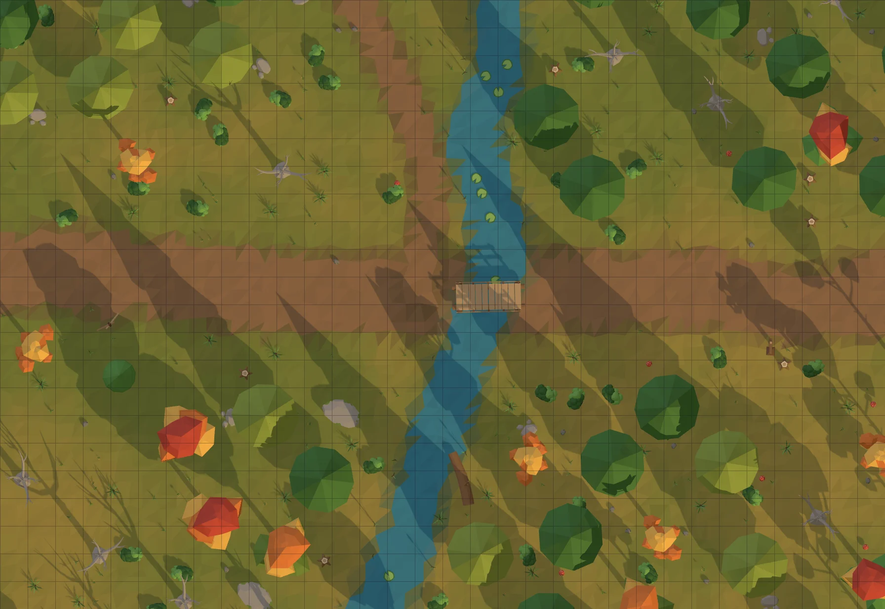An autumn forest road crossing a stream on a log bridge